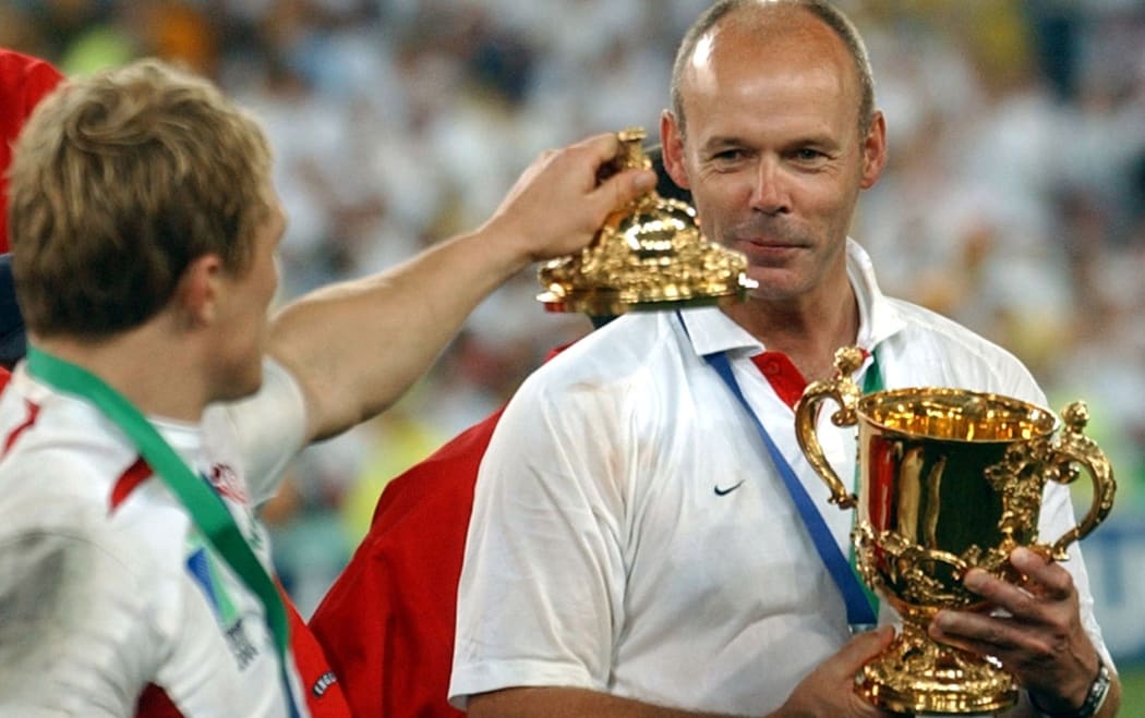 England's Jonny Wilkinson offers the lid of the Rugby World Cup to coach Clive Woodward after winning the 2003 tournament.