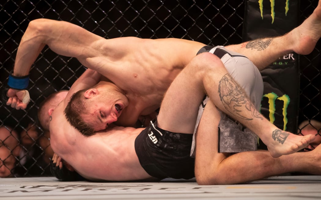 New Zealand fighter Dan Hooker grapples with Paul Felder in their UFC lightweight bout in Auckland.