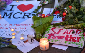 Messages and flowers outside Albert Square in Manchester.
