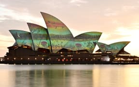 The sails of the Sydney Opera House are illuminated with the artwork “River Life” by Wiradjuri artist James P. Simon on Australia Day in Sydney on January 26, 2025. (Photo by AYUSH KUMAR / AFP)
