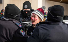 Police arrest a demonstrator against Covid-19 mandates in Ottawa on 18 February 2022.