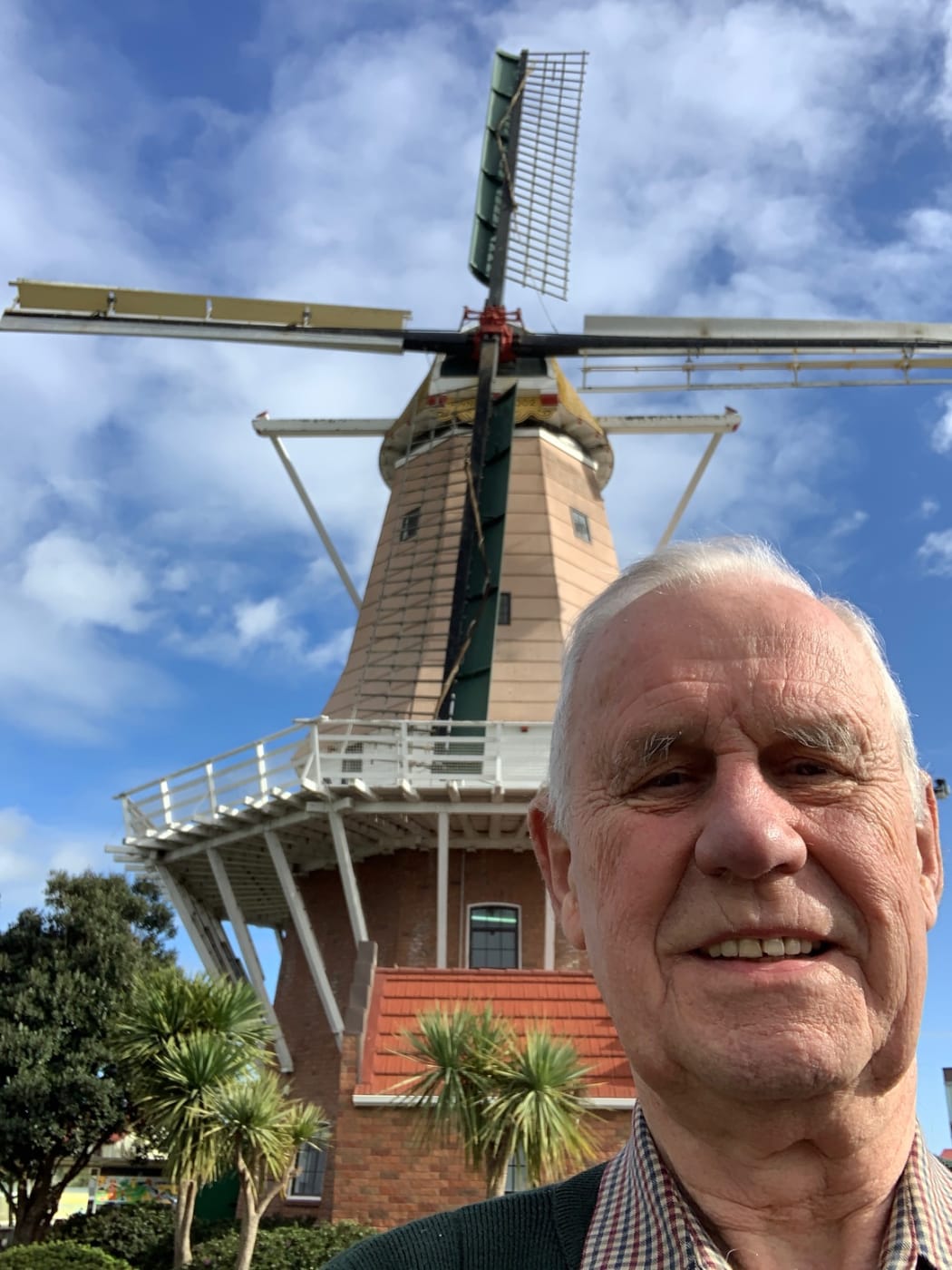 John Girling in front of the Foxton windmill - a working replica of a Dutch 17th century flour mill.