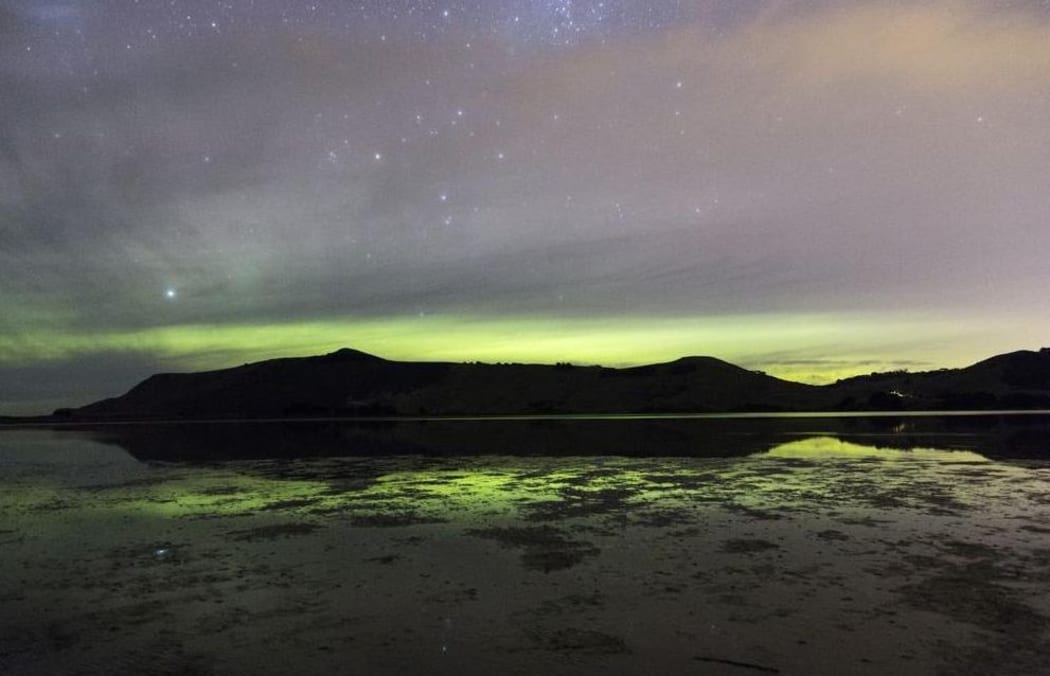 Sandymount on Otago Peninsula silhouetted by the Aurora.