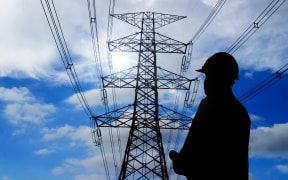 silhouette of engineers standing at electricity station