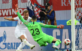 England's forward Harry Kane (L) attempts to score past Croatia's goalkeeper Danijel Subasic during the Russia 2018 World Cup semi-final football match between Croatia and England at the Luzhniki Stadium in Moscow on July 11, 2018.