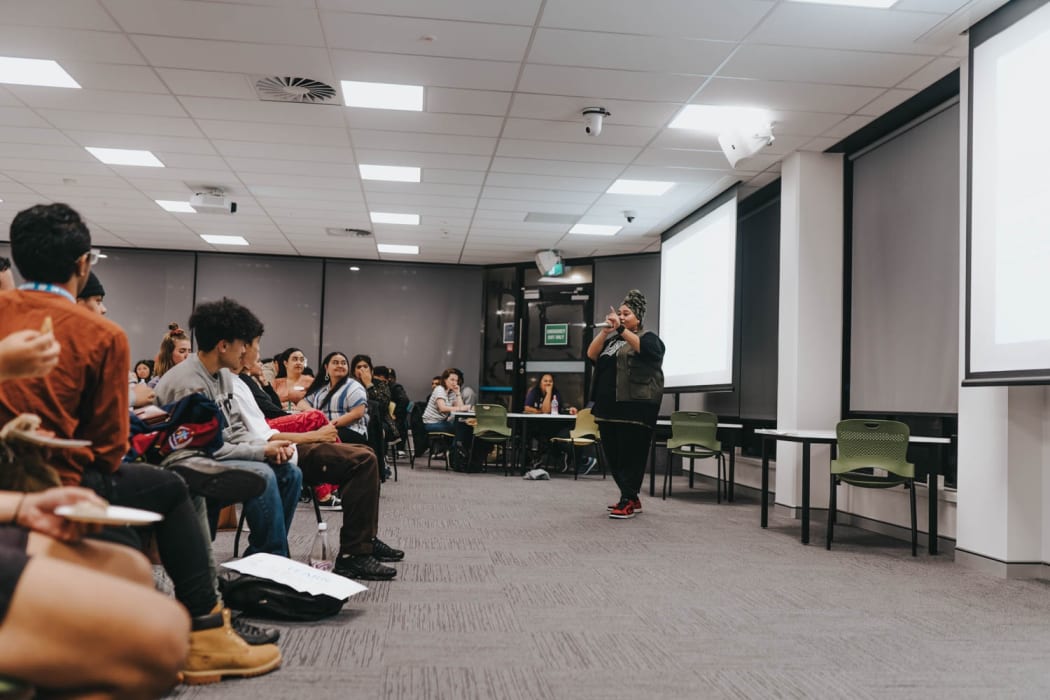 Brown Paper Bag co-director Carmel-Maria Savaiinaea enticing students to join the cause.
