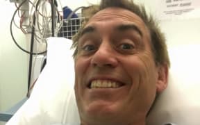 Jason Gunn in hospital bed