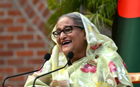 Bangladesh's Prime Minister Sheikh Hasina laughs while speaking to the media, a day after she won the 12th parliamentary elections, in Dhaka on January 8, 2024. (Photo by INDRANIL MUKHERJEE / AFP)