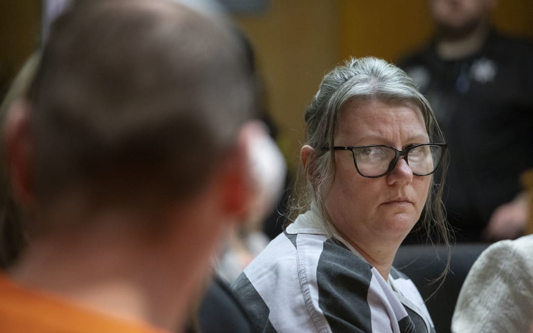 Jennifer Crumbley looks at her husband James Crumbley during their sentencing on four counts of involuntary manslaughter for the deaths of four Oxford High School students by their son, mass school shooter Ethan Crumbley, on April 9, 2024 at Oakland County Circuit Court in Pontiac, Michigan. The Crumbleys are the first parents in U.S. history to be criminally tried and convicted for a mass school shooting that was committed by their child.