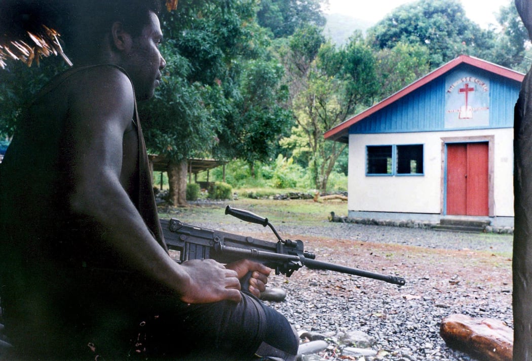 Photo taken on the 20th of July 2003. A militiaman loyal to renegade warlord Harold Keke guards the church where hostages Father Peter Kesimo, Father Alfred Tabo and Father Benjamin Kunu are being held in the Guadalcanal Liberation Front stronghold of Mbiki on the remote Weather Coast.