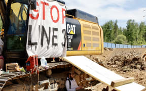 Environmental activists chain themselves to construction equipment at the Line 3 pipeline pumping station near the Itasca State Park, Minnesota on 7 June, 2021.