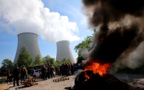 Workers block the access to the nuclear power plant of Nogent-sur-Seine with a barricade of fire.