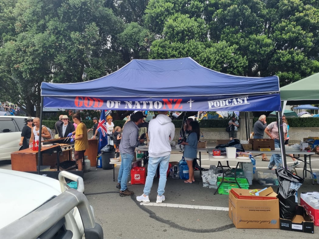 A sausage sizzle and coffee and tea station, with a generator being set up for protesters.