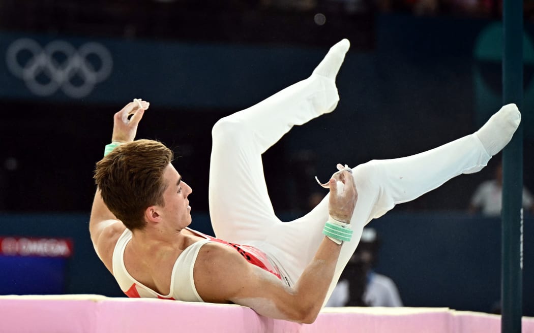 Canada's Felix Dolci falls down during the horizontal bar event of the artistic gymnastics men's all-around final during the Paris 2024 Olympic Games at the Bercy Arena in Paris, on July 31, 2024. (Photo by Gabriel BOUYS / AFP)