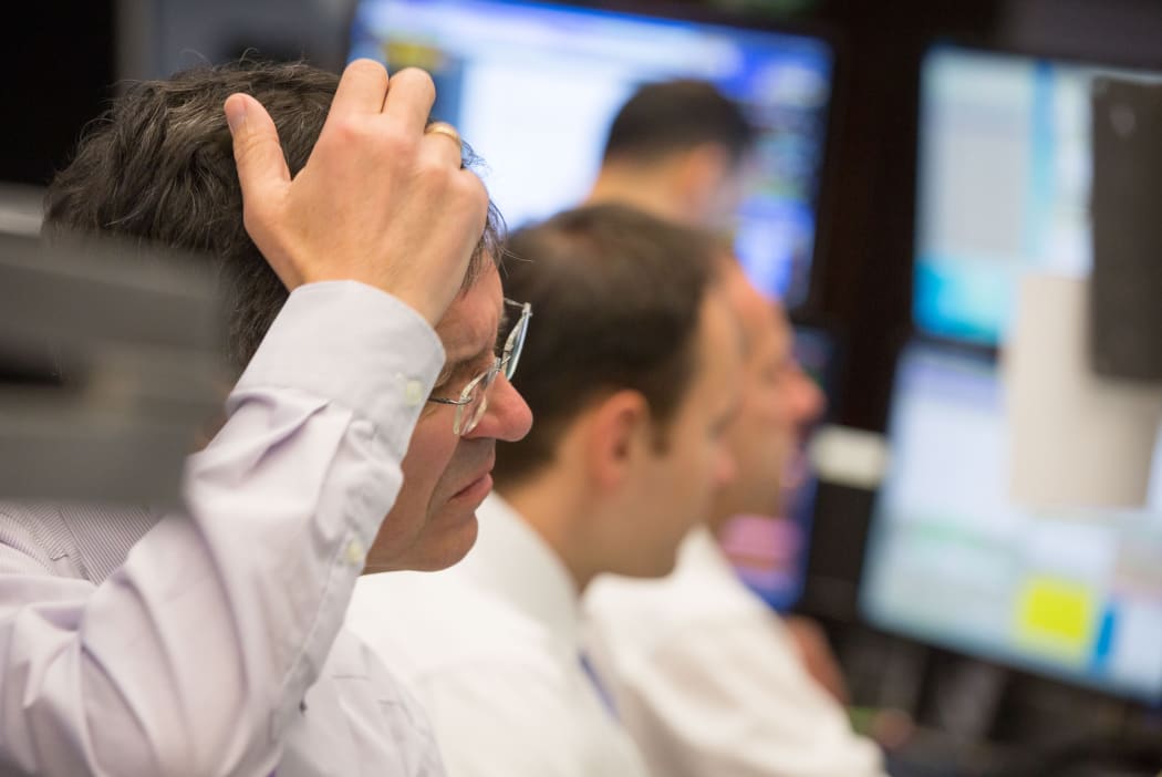German stock traders watch as the market  is rattle by Chinese volatility.