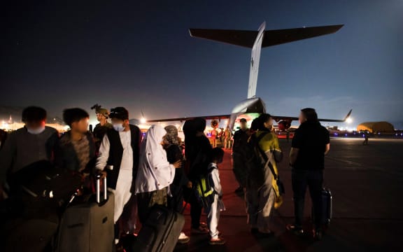 Ppeople forming a line to board the Royal Australian Air Force C-17A Globemaster at Hamid Karzai International Airport in Kabul.
