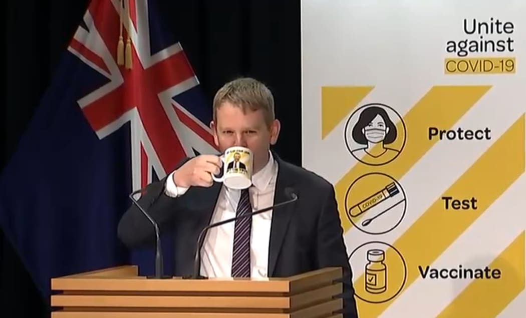 Covid-19 Response Minister Chris Hipkins with the 'spread your legs, not the virus' mug.