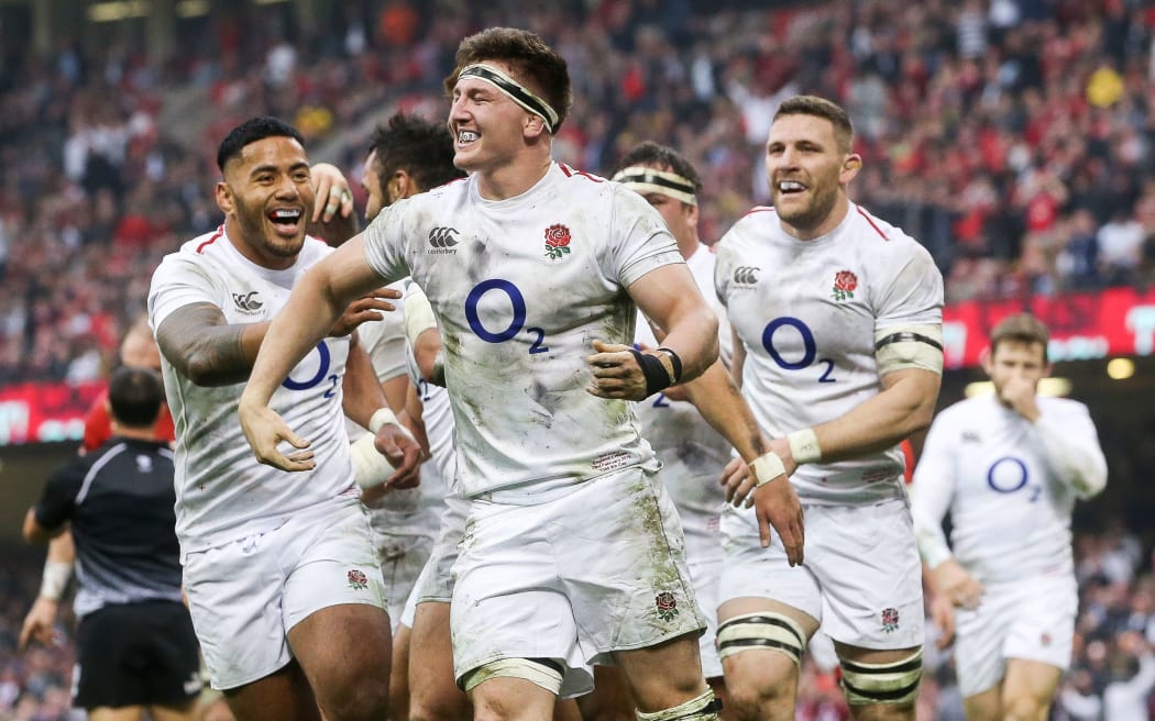 England's Tom Curry celebrates scoring a  try.