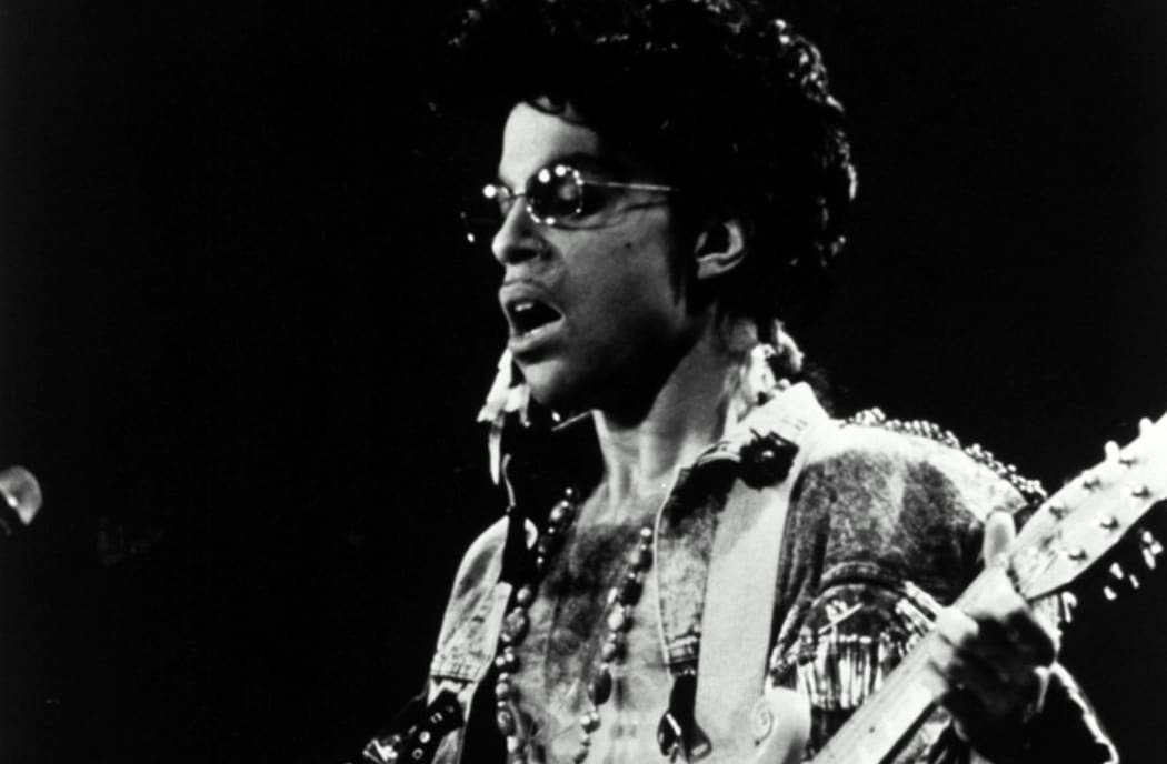 Prince performing on stage in Amsterdam in his concert movie Sign o’ the Times
