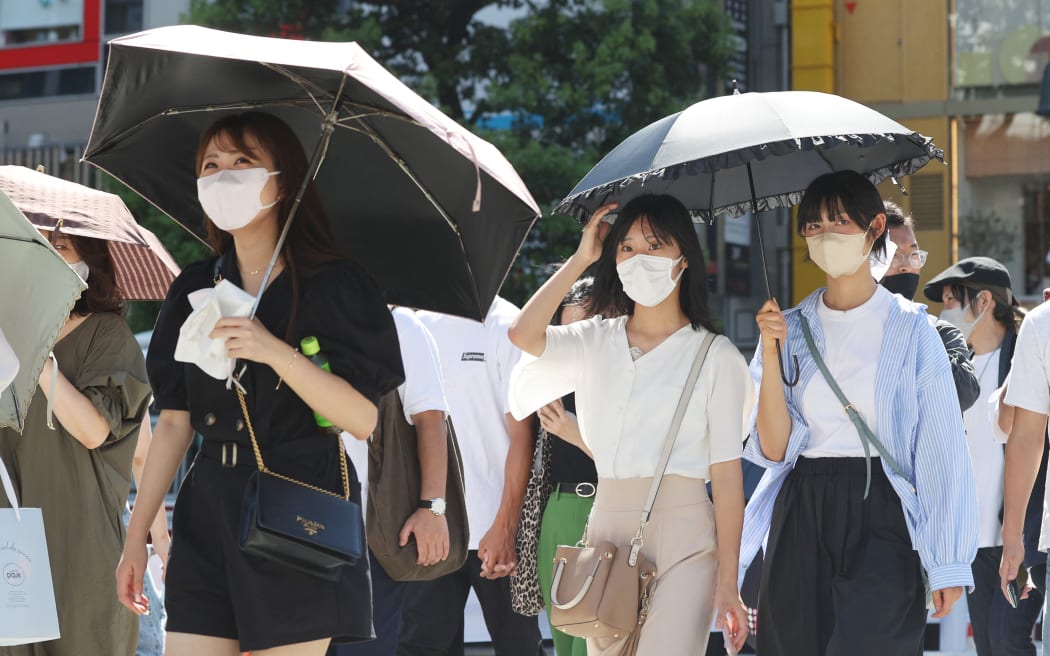 Tokyo residents were warned about the risk of heat stroke while wearing masks during a heatwave in June.