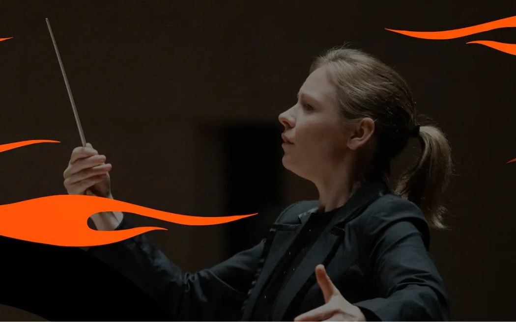 Gemma New conducting an orchestra