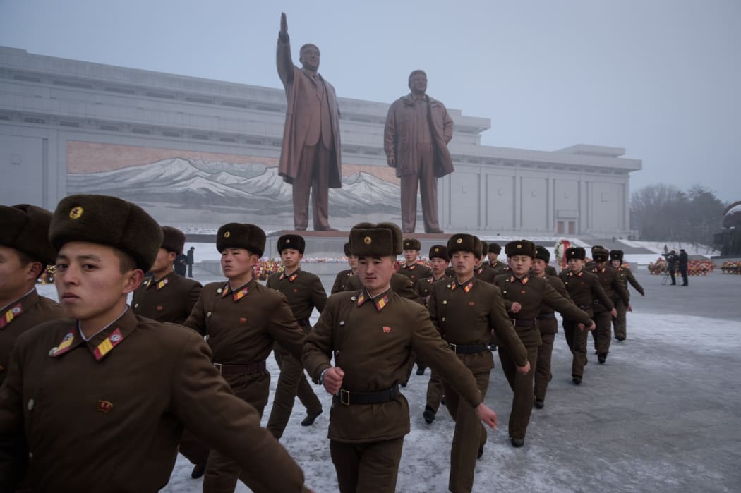 Korean People's Army soldiers leave after bowing before the statues of late North Korean leaders Kim Il Sung and Kim Jong Il during National Memorial Day in Pyongyang on 17 December, 2018.