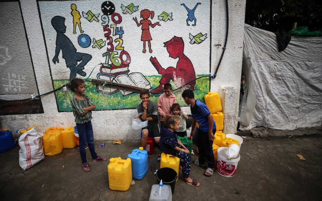 Displaced people are seen in the yard of a United Nations Relief and Works Agency for Palestine Refugees (UNRWA) school in Khan Yunis, in the southern Gaza Strip on 30 October 30, 2023, amid ongoing battles between Israel and the Palestinian Hamas movement.