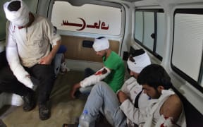 Wounded opposition fighters in an ambulance in Aleppo, as clashes erupted in an area designated as a humanitarian corridor for civilians to leave the embattled city, despite an announced pause in the Syrian army's Russian-backed offensive.