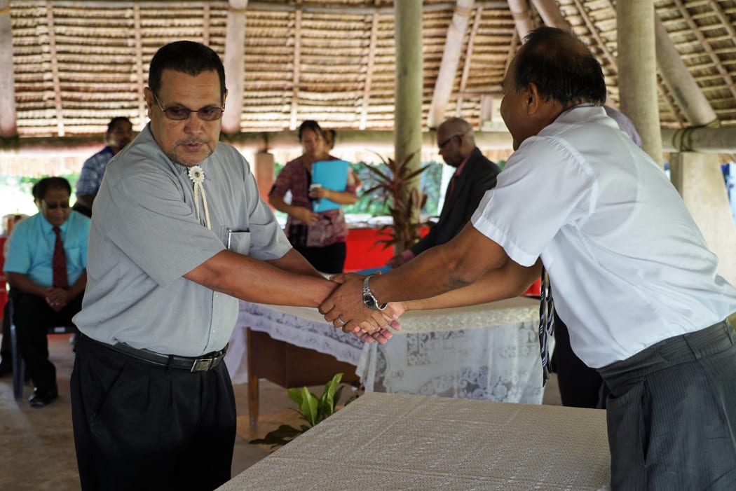 Attorney General - Honourable Natan Teewe shakes hands with President Taneti Maamau