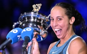 USA's Madison Keys celebrates with the Daphne Akhurst Memorial Cup after victory against Belarus' Aryna Sabalenka during their women's singles final match on day fourteen of the Australian Open tennis tournament in Melbourne on January 25, 2025.