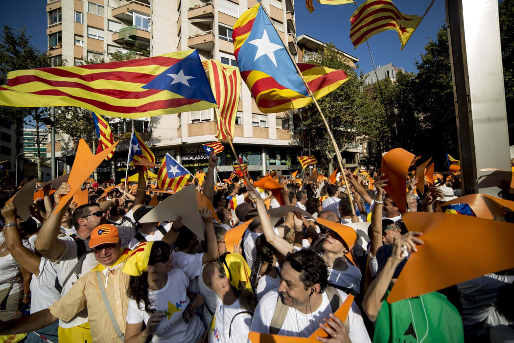 Demonstrators wave "Estelada" flags (pro-independence Catalan flags) during celebrations of Catalonia's National Day.