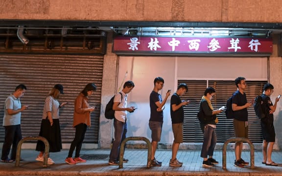 People queue to cast their vote during the district council elections in Tseung Kwan O district in Hong Kong.