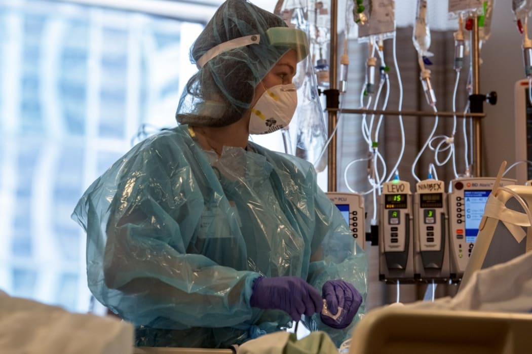 This image released by Northwestern Medicine, shows nurses at the Covid-19 Intensive Care Unit of Northwestern Memorial Hospital in Chicago.