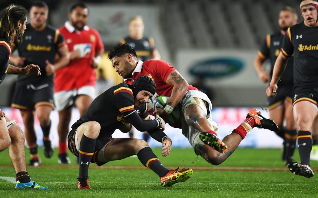 Tonga's Valentino Mapapalangi collides with Wales flyhalf Sam Davies.