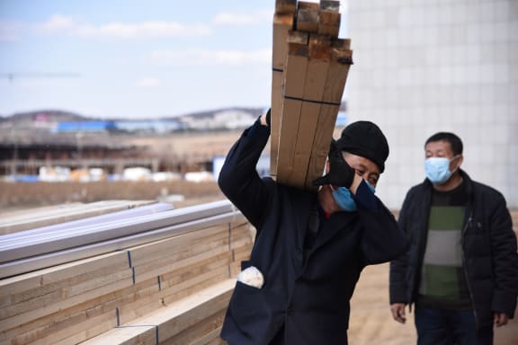 People work at the construction site of a temporary hospital in Suifenhe, northeast China's Heilongjiang Province, April 10, 2020.