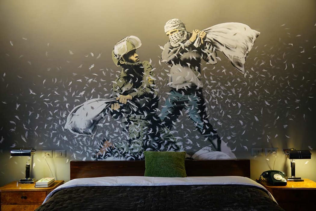 A Banksy artwork in a room at the Walled Off Hotel in Bethlehem.