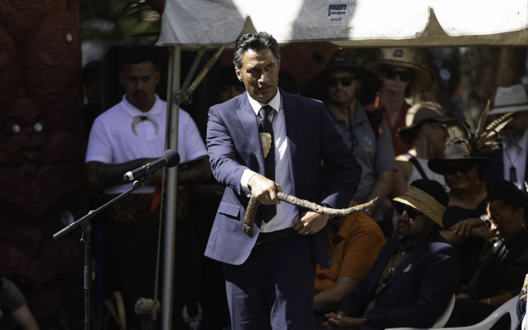 Bayden Barber of Ngāti Kahungunu speaks as a delegation including representatives from Kīngitanga, Rātana, Parihaka and Te Pāti Māori is welcomed on to Te Whare Rūnanga at the Treaty grounds, on 4 February, 2024.