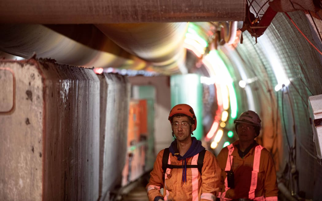 Workers prepare the tunnel boring machine to dig the tunnel for the central interceptor stormwater system under the Manukau Harbour.