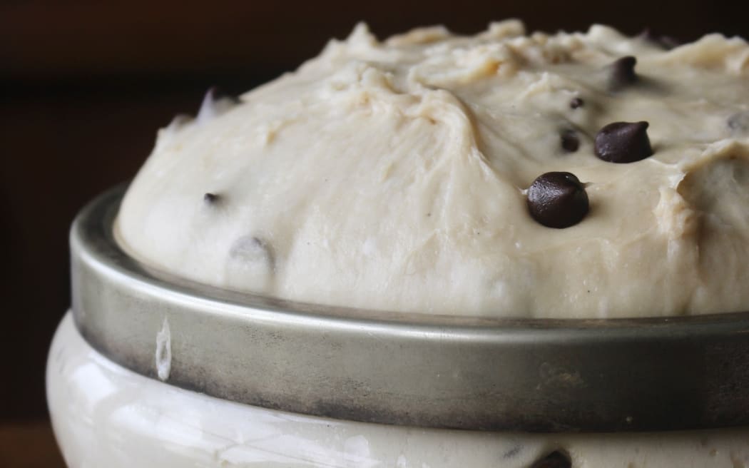 Image of dough rising in a cut glass bowl with silver rim.