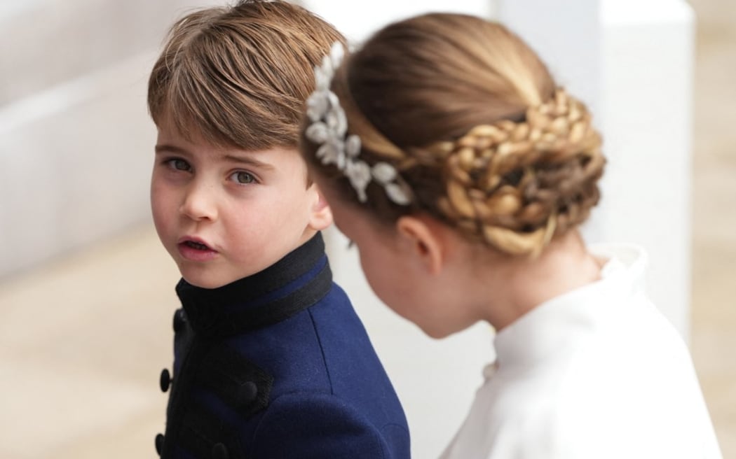Prince Louis arrives at the coronation with his sister Princess Charlotte.