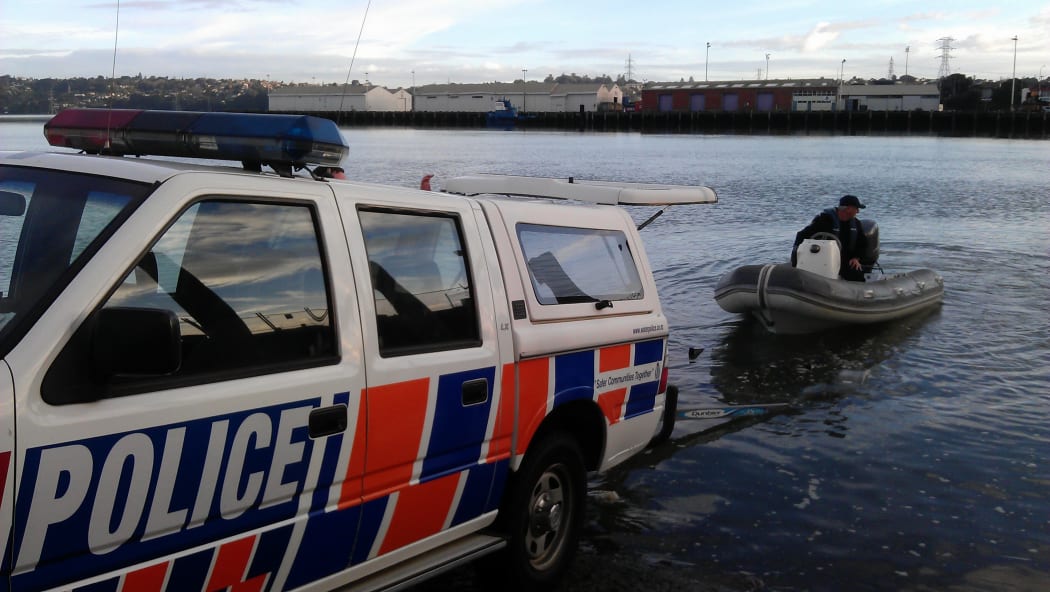 The Police Maritime Unit enters the water at Mangere bridge.