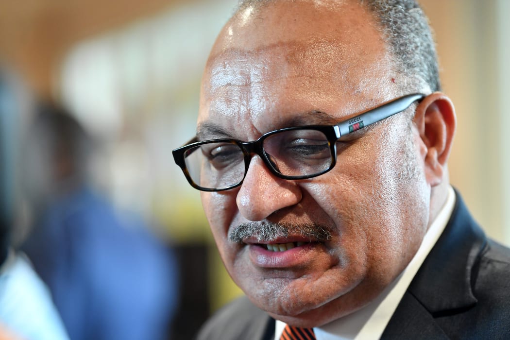 Papua New Guinea Prime Minister Peter O'Neill talks to the media as he visits the international media center, set up for Asia-Pacific Economic Cooperation (APEC) summit, in Port Moresby on November 14, 2018. (Photo by Saeed KHAN / AFP)