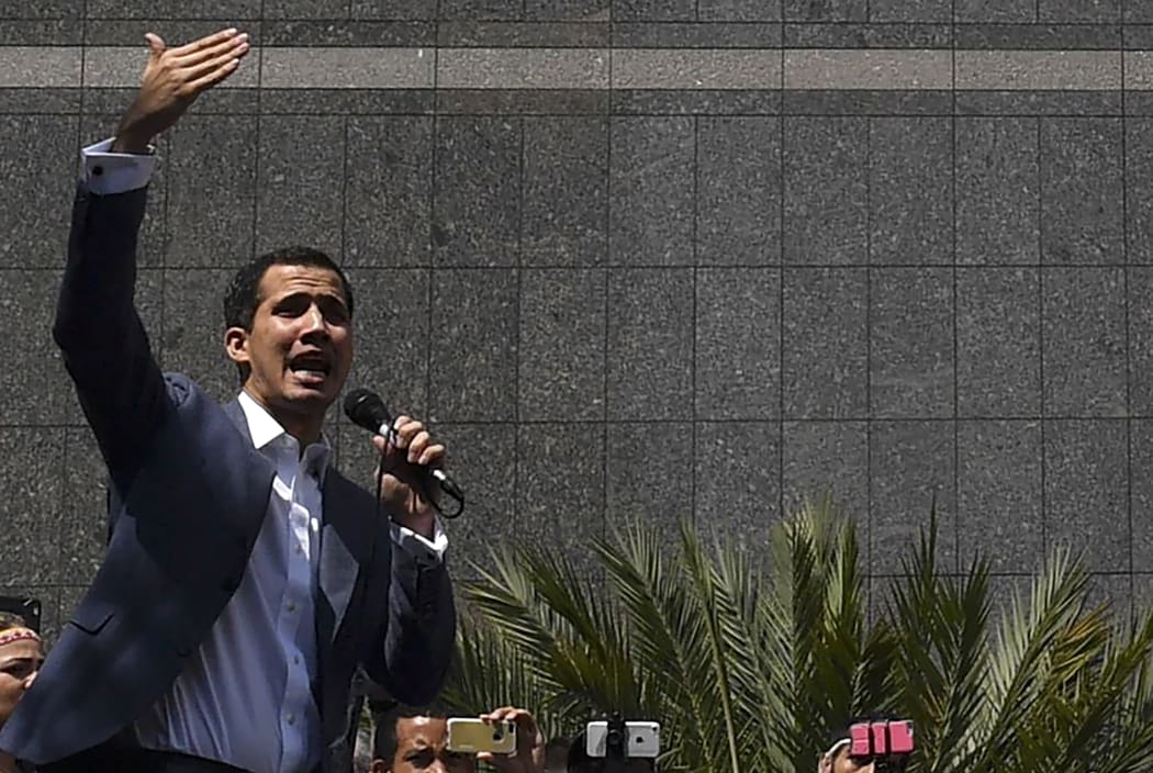 The president of Venezuela's opposition-led National Assembly Juan Guaido speaks to the crowd during an extraordinary open meeting in front of the headquarters of the UN Development Programme in Caracas.