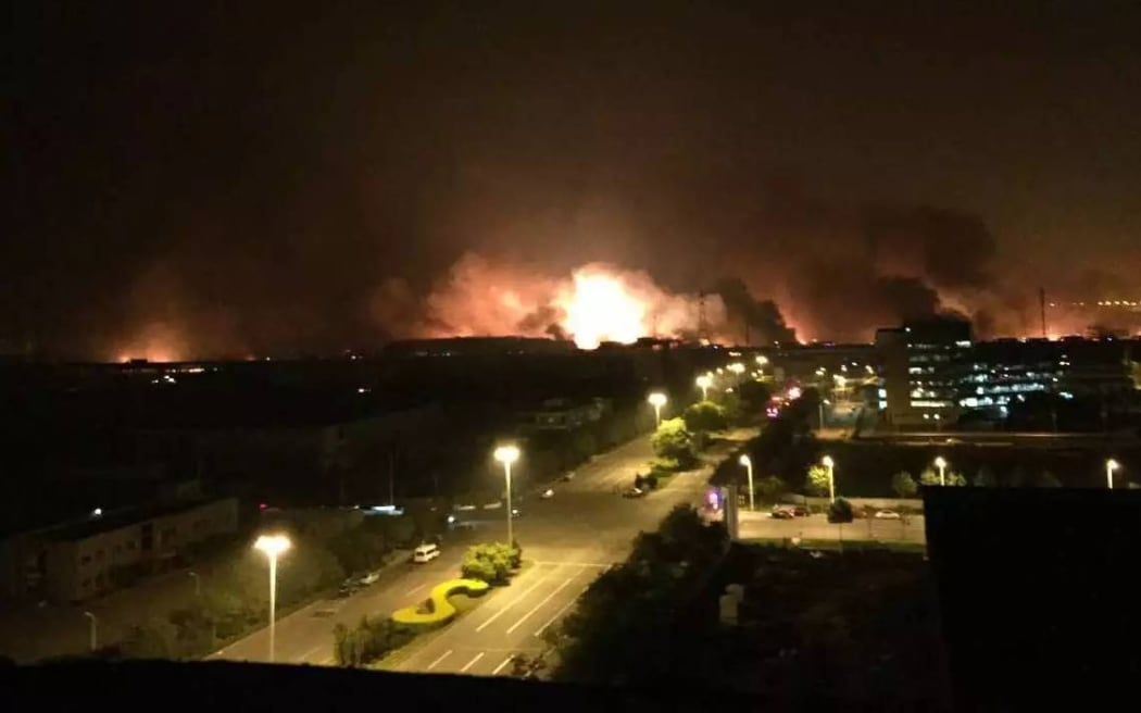 Smoke and fire are seen after an explosion in the Binhai New Area in north China's Tianjin Municipality on 13 August 2015.