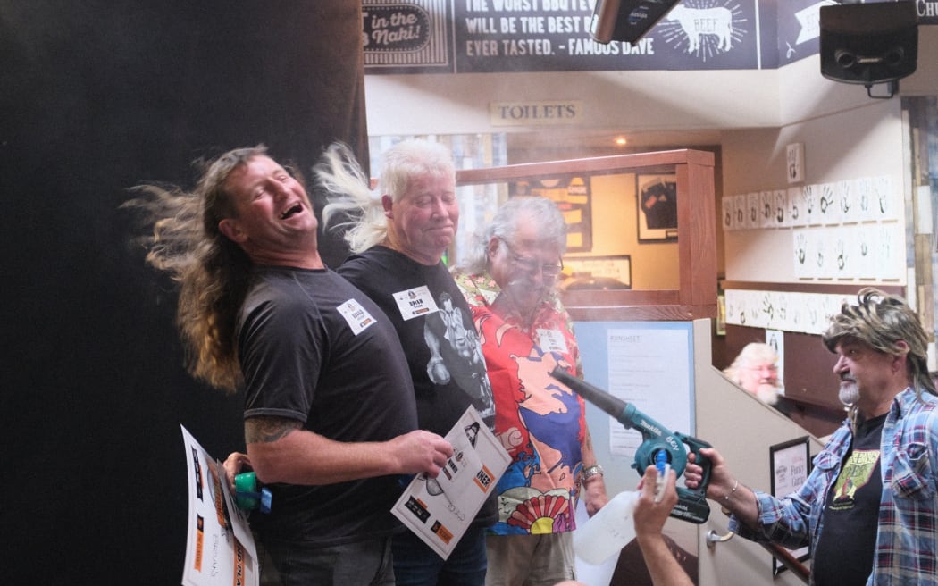 Contestants have their mullets blown in the breeze at the 2022 Crowded House contest.