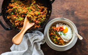 Stir-fried quinoa, broccoli and kimchi with fried eggs.