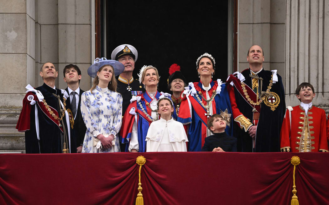 (Left to right) Prince Edward Duke of Edinburgh, James, Lady Louise Windsor, Vice Admiral Timothy Laurence, Sophie, Duchess of Edinburgh, Princess Charlotte of Wales, Princess Anne, Princess Royal, Catherine, Princess of Wales, Prince Louis of Wales, Prince William, Prince of Wales and a page of honour on the Buckingham Palace balcony to view the Royal Air Force fly-past in central London on May 6, 2023, after the coronations of Britain's King Charles III and Britain's Queen Camilla. - The set-piece coronation is the first in Britain in 70 years, and only the second in history to be televised. Charles will be the 40th reigning monarch to be crowned at the central London church since King William I in 1066. (Photo by Oli SCARFF / AFP)