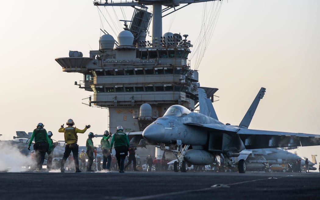 This 1 April photo from the US Navy shows a F/A-18E Super Hornet preparing for launch on the USS Harry S. Truman.