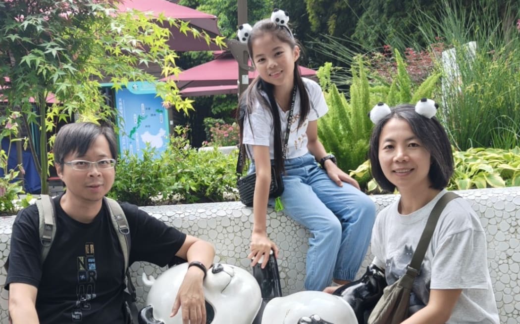 Ann Ng, who plays Matilda in the musical in Auckland 2024, with her father Andy Deng (left) and mother Amy Wu.