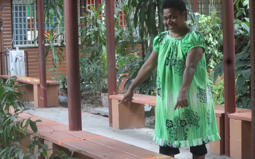 A Kopkop College teacher shows how benches have been marked to encourage social distancing.